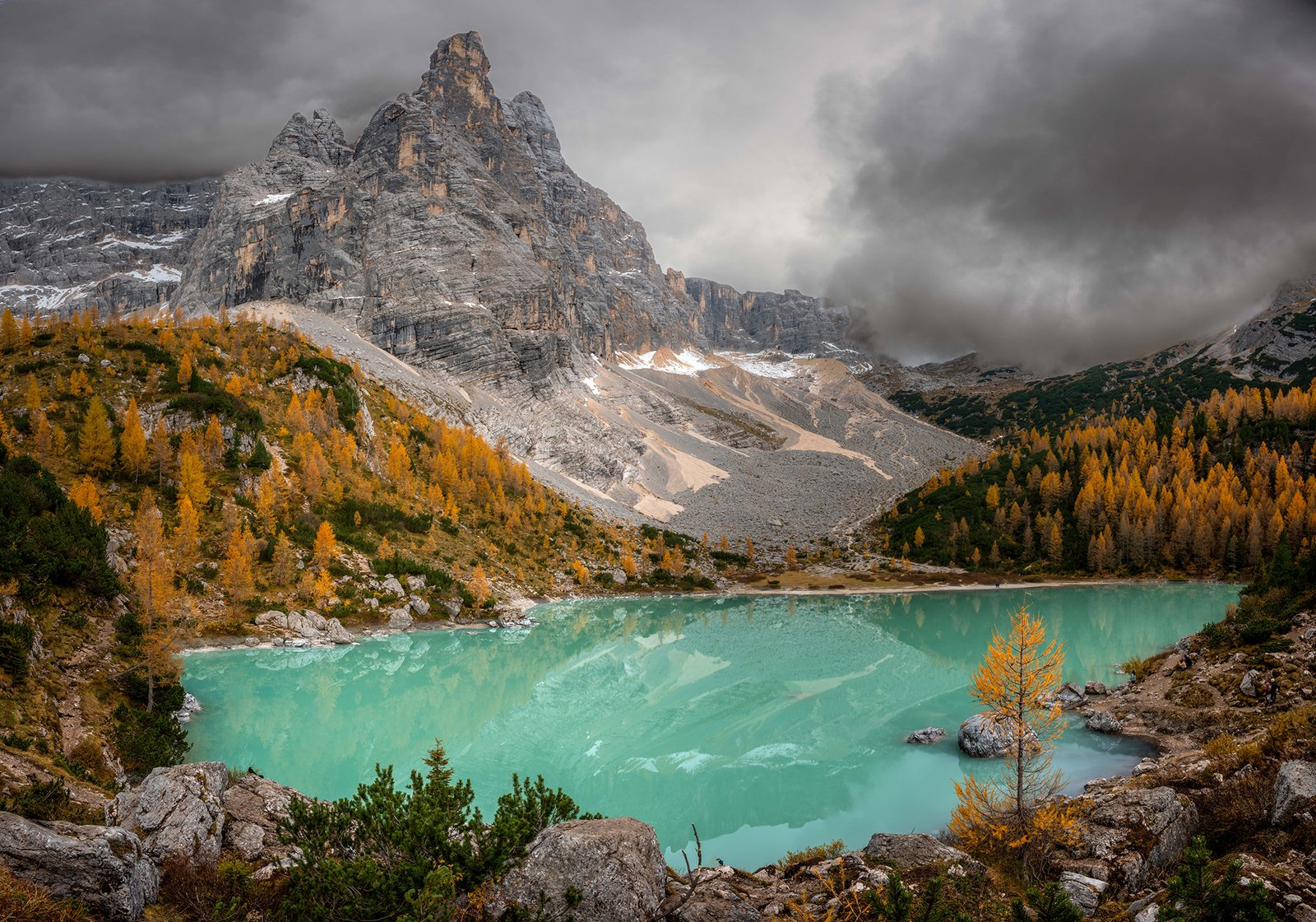 Autumn landscape in the Dolomites with colorful forests and mountain peaks